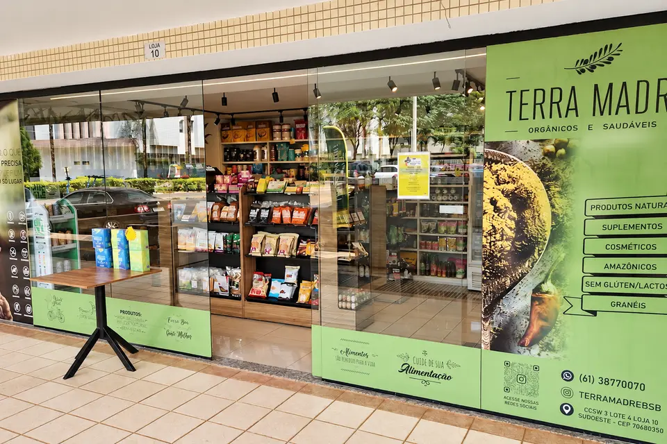 Vitrine da Loja 2 da Terra Madre na CCSW 3, com adesivo verde-lima e produtos à mostra